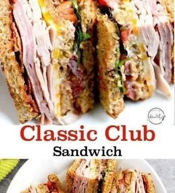 Delicious club sandwich with turkey, ham, and bacon stacked high on a plate.