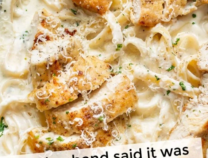 Creamy Chicken Fettuccine Alfredo served with fresh parsley and grated Parmesan cheese