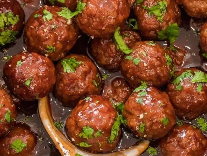 Plate of delicious grape jelly meatballs served as an appetizer.