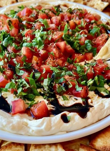 A vibrant Bruschetta Dip served with crunchy bread for dipping.