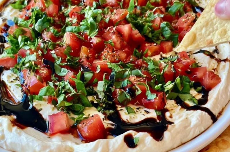 A vibrant Bruschetta Dip served with crunchy bread for dipping.