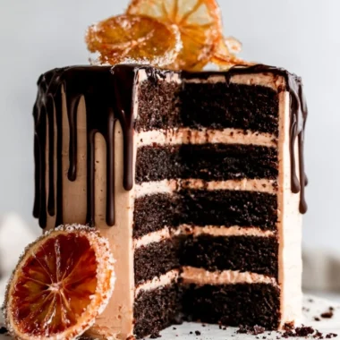 Dark chocolate blood orange cake topped with vibrant orange slices.