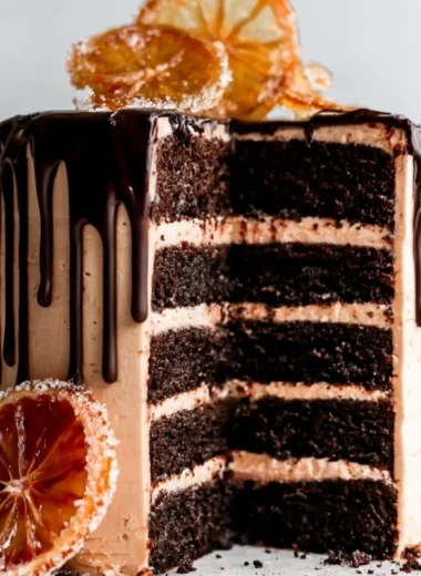 Dark chocolate blood orange cake topped with vibrant orange slices.