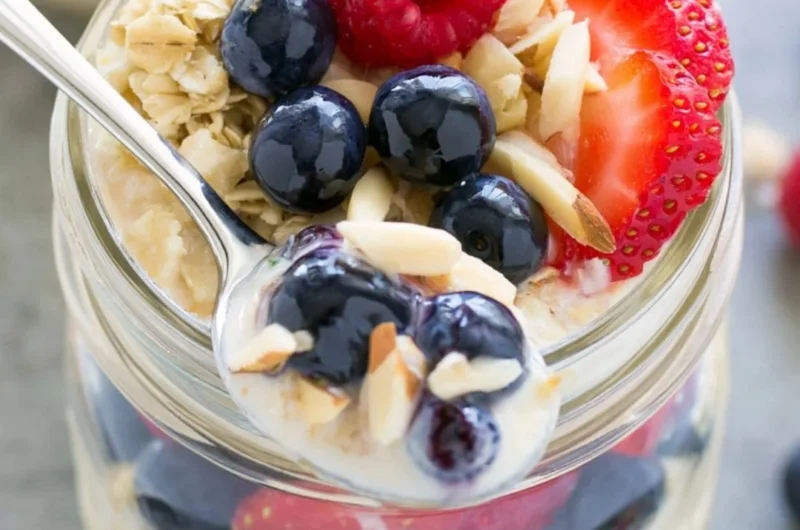 Bowl of easy overnight oats topped with fresh fruits and nuts.