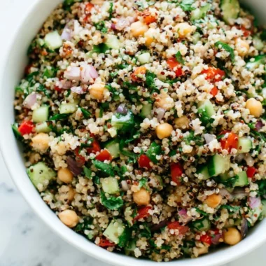 Healthy quinoa salad with vegetables and dressing in a bowl