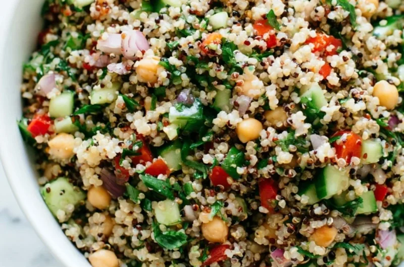 Healthy quinoa salad with vegetables and dressing in a bowl