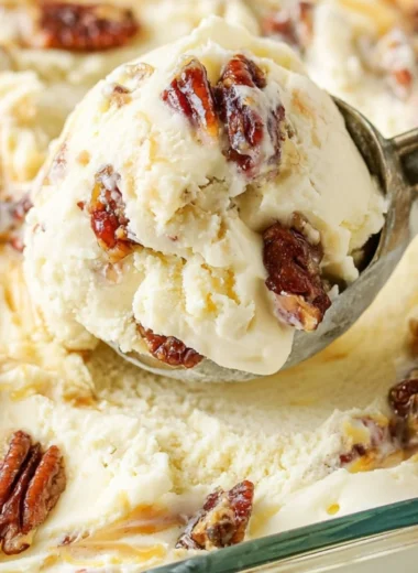 Bowl of homemade buttered pecan ice cream topped with toasted pecans
