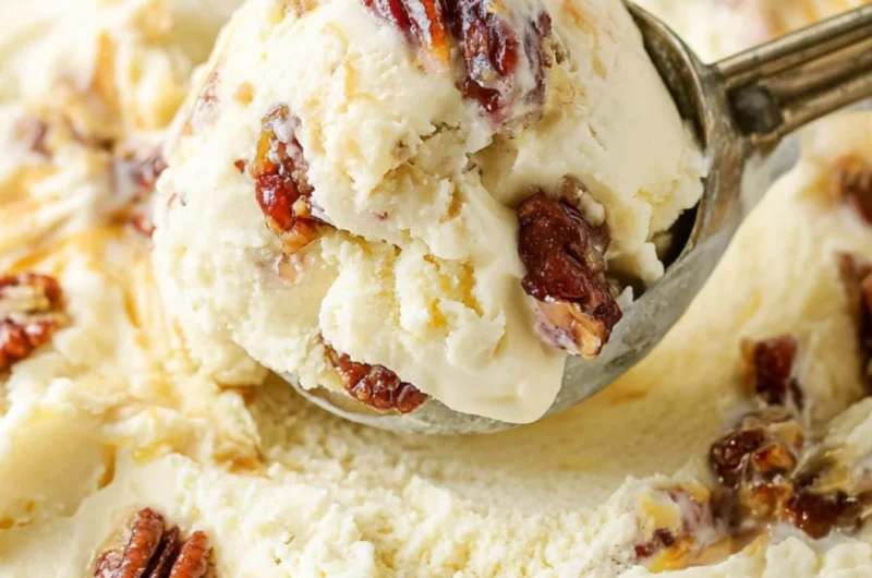 Bowl of homemade buttered pecan ice cream topped with toasted pecans