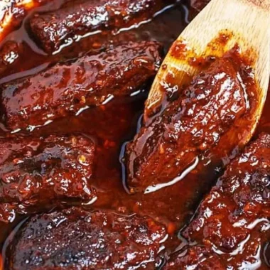 Korean braised short ribs served with sides in a rustic dish