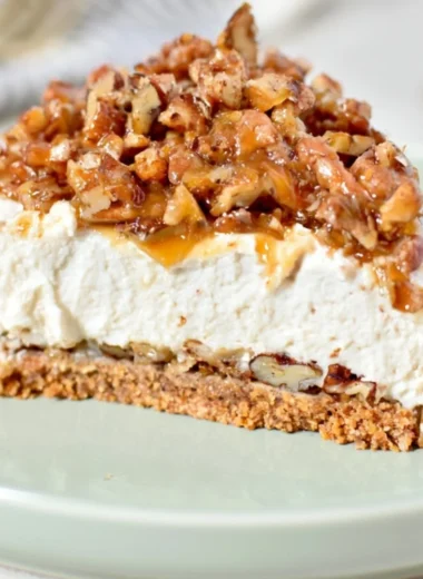 No-Bake Keto Pecan Pie Cheesecake topped with pecans and caramel sauce