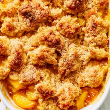 Delicious homemade Peach Cobbler with golden crust and juicy peach filling.
