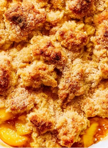 Delicious homemade Peach Cobbler with golden crust and juicy peach filling.