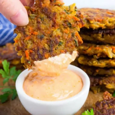 Crispy potato fritters made with red lentils, served on a plate.