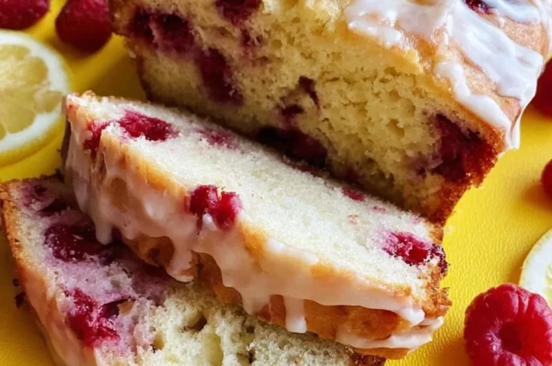 Freshly baked Raspberry Lemon Loaf with vibrant raspberries and lemon glaze.