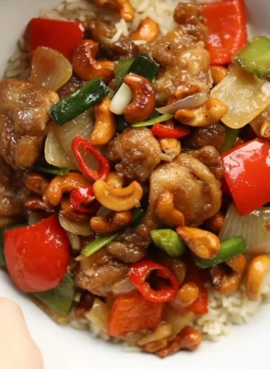 Delicious plate of Thai Cashew Chicken garnished with fresh herbs and vegetables
