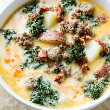 A steaming bowl of Instant Pot Tuscan Soup garnished with fresh herbs