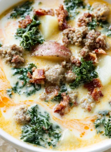 A steaming bowl of Instant Pot Tuscan Soup garnished with fresh herbs