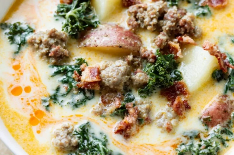 A steaming bowl of Instant Pot Tuscan Soup garnished with fresh herbs