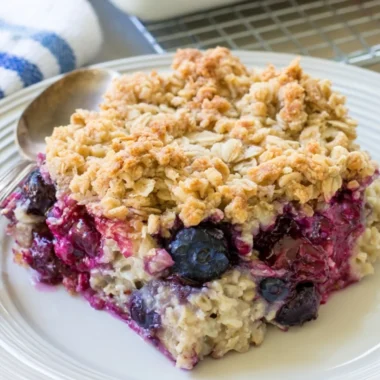 Delicious Blueberry Baked Oatmeal served in a bowl topped with fresh blueberries.