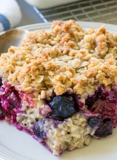 Delicious Blueberry Baked Oatmeal served in a bowl topped with fresh blueberries.