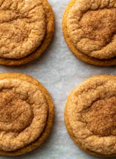 Freshly baked chewy pumpkin cookies on a rustic wooden table