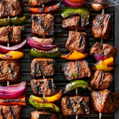 Cozy beef shish kabob on a grill with colorful vegetables