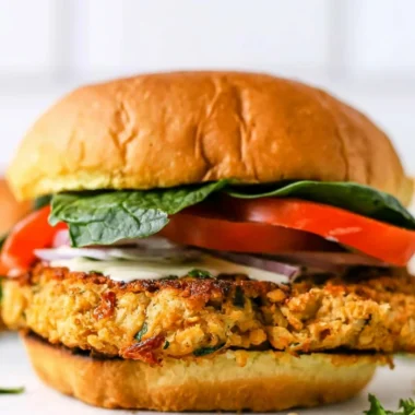 Delicious Cozy Chickpea Cauliflower Burger served on a plate with fresh greens