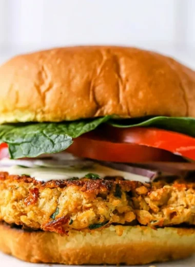 Delicious Cozy Chickpea Cauliflower Burger served on a plate with fresh greens