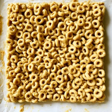 Cozy Peanut Butter and Cheerio Bars on a plate, a delicious snack treat.