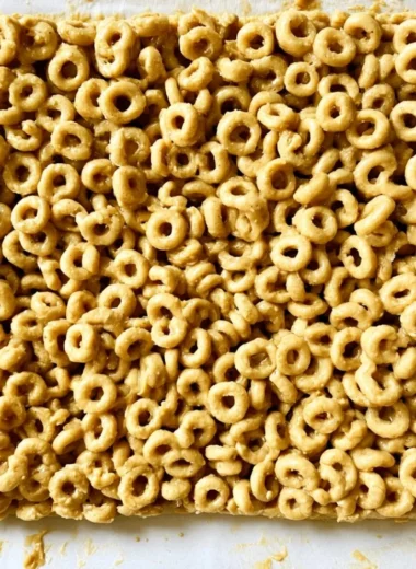 Cozy Peanut Butter and Cheerio Bars on a plate, a delicious snack treat.