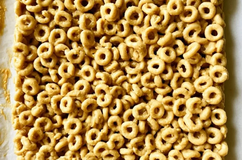 Cozy Peanut Butter and Cheerio Bars on a plate, a delicious snack treat.