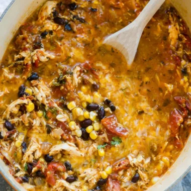 Bowl of easy chicken tortilla soup topped with crispy tortilla strips and cilantro.
