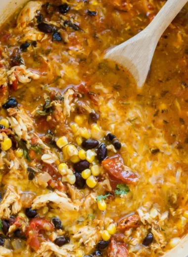 Bowl of easy chicken tortilla soup topped with crispy tortilla strips and cilantro.
