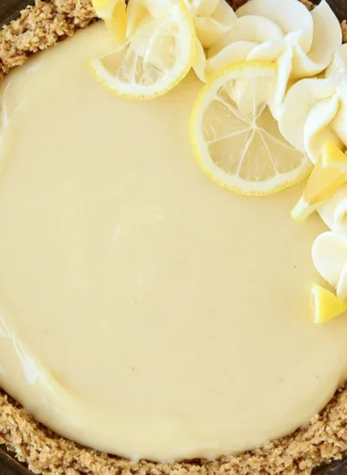 Delicious homemade easy lemon cream pie with whipped cream topping and lemon zest