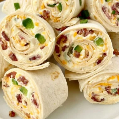 Jalapeno poppers pinwheels sliced on a plate with garnishes