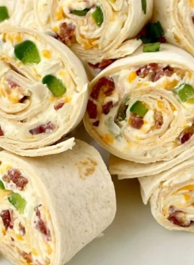 Jalapeno poppers pinwheels sliced on a plate with garnishes