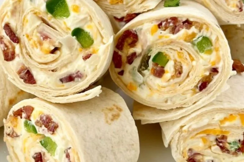 Jalapeno poppers pinwheels sliced on a plate with garnishes