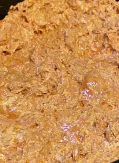 Bowl of warm and creamy buffalo chicken dip with tortilla chips