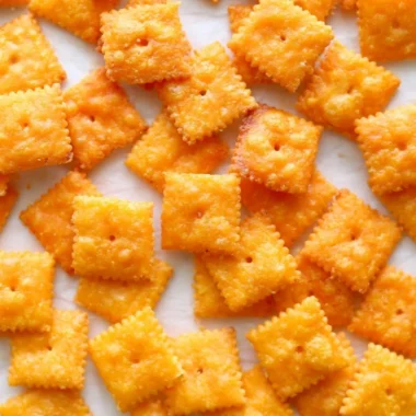 Delicious homemade cheese crackers on a wooden serving board