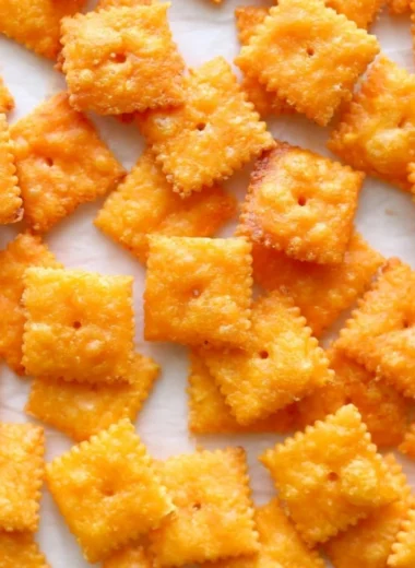 Delicious homemade cheese crackers on a wooden serving board